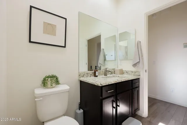 a bathroom with a toilet sink and mirror