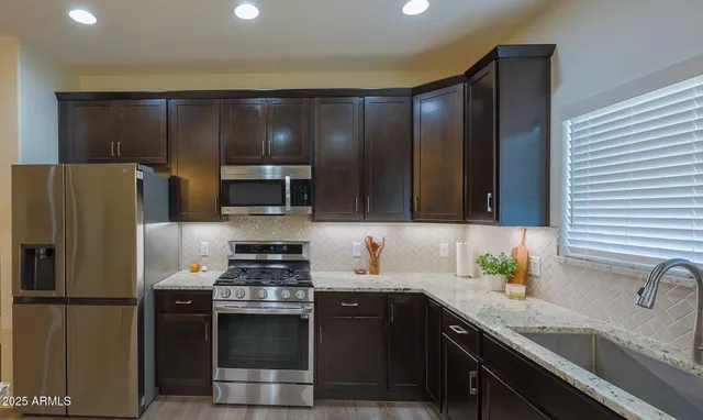 a kitchen with a refrigerator and a sink