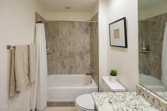 a bedroom with a large bed and a chair