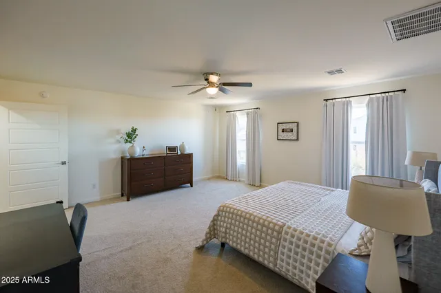 a bathroom with a granite countertop double vanity sink and a mirror