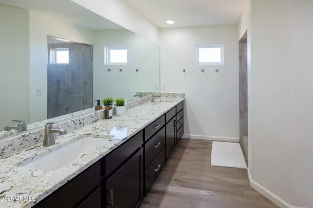 a bathroom with a shower and a glass door