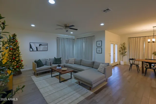 a living room with furniture and wooden floor