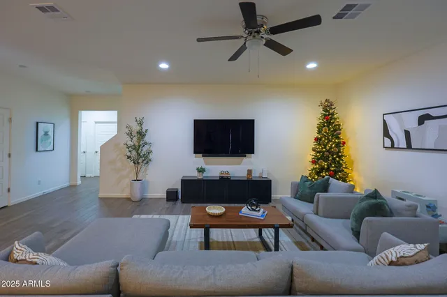 a living room with furniture and a flat screen tv