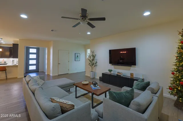 a living room with furniture a rug and a flat screen tv