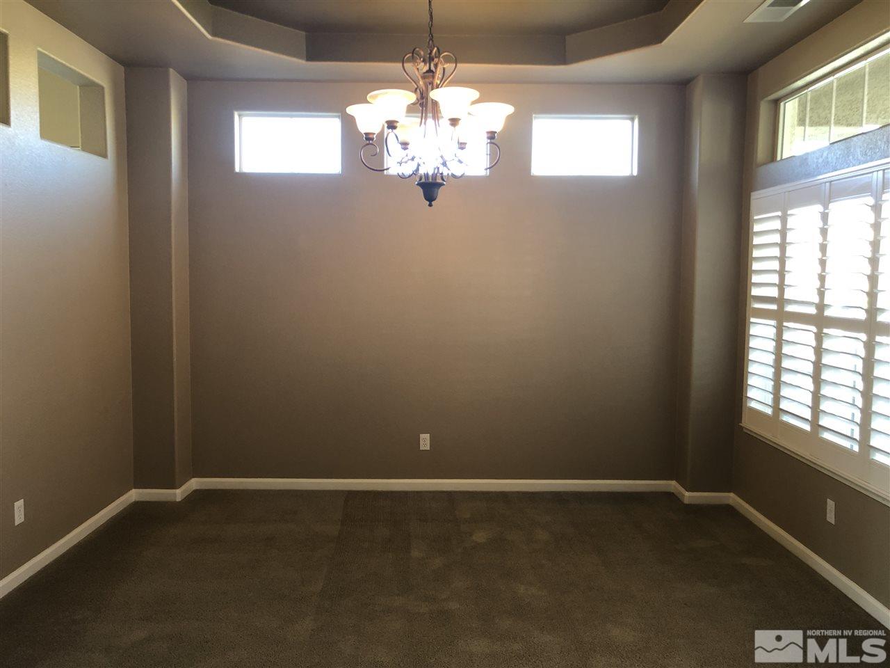 1671 Sewell Drive Reno, NV 89521 - Photo 3 of 16 a dining room with window and chandelier