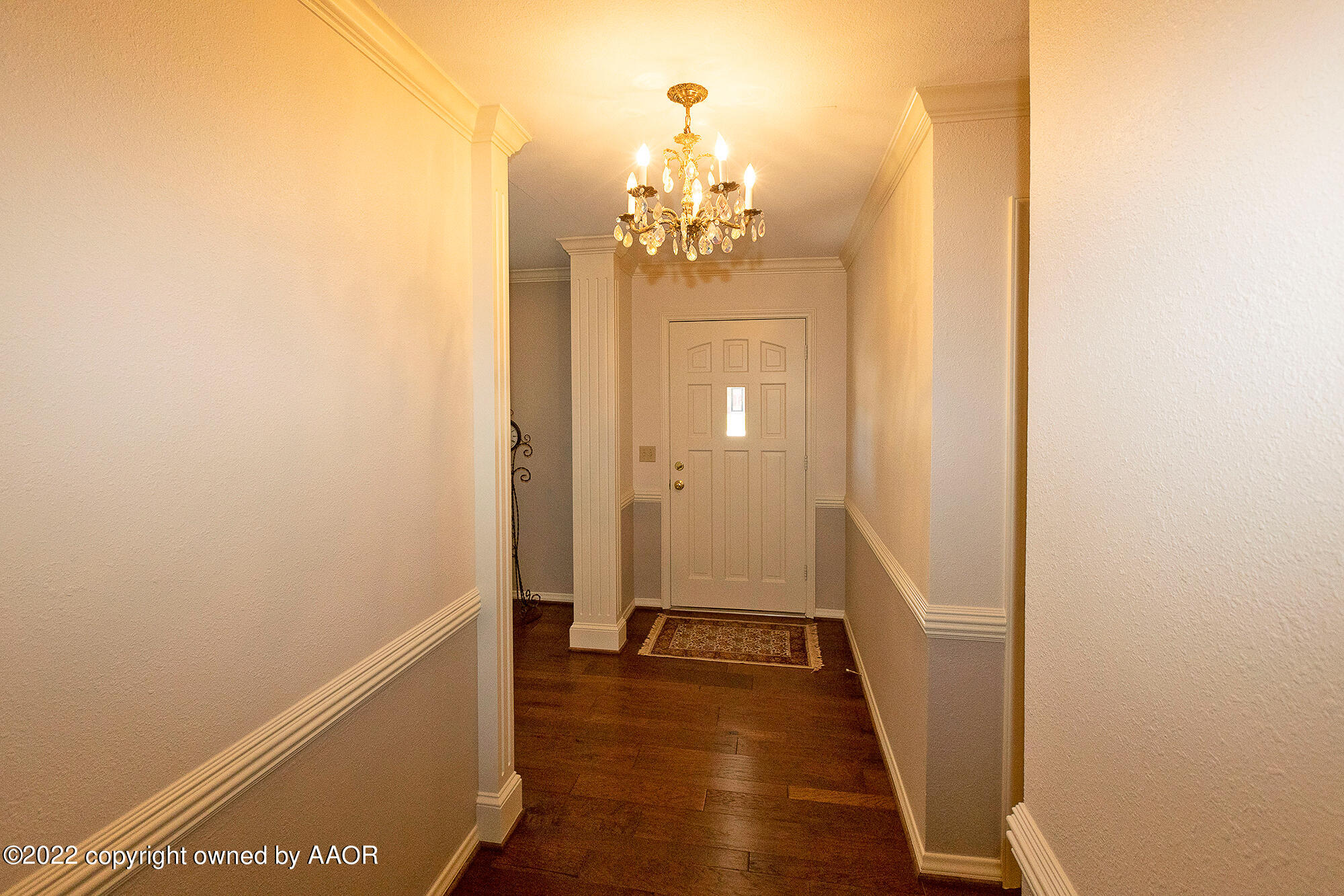 6910 Elmhurst Road Amarillo, TX 79106 - Photo 4 of 36 a view of a hallway with wooden floor