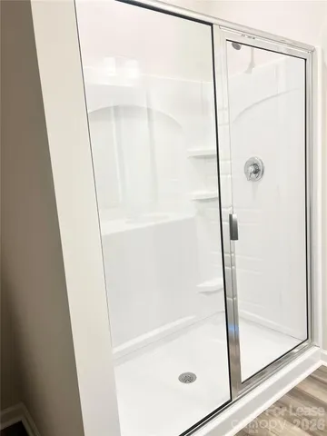 a bathroom with a glass shower door