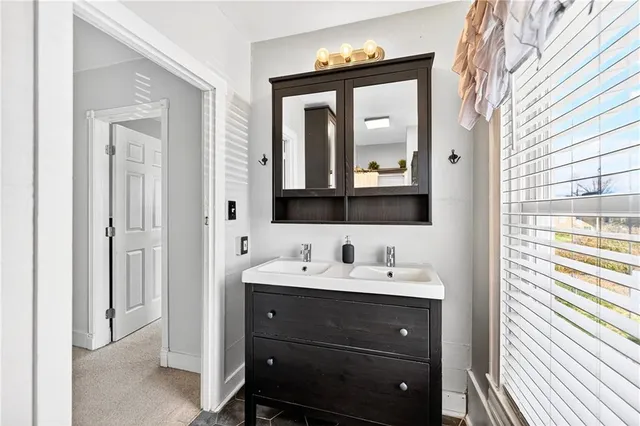a bathroom with a double vanity sink and mirror