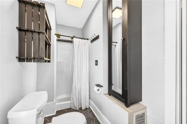 a bathroom with a toilet a sink and a mirror