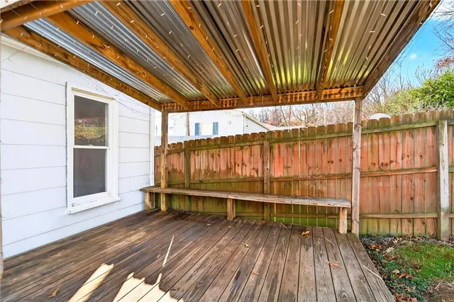 a wooden bench sitting in front of a building
