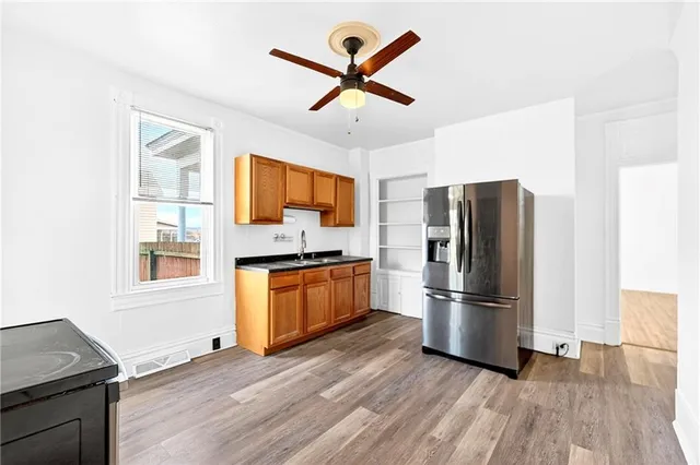 a kitchen with stainless steel appliances granite countertop a refrigerator microwave and a stove