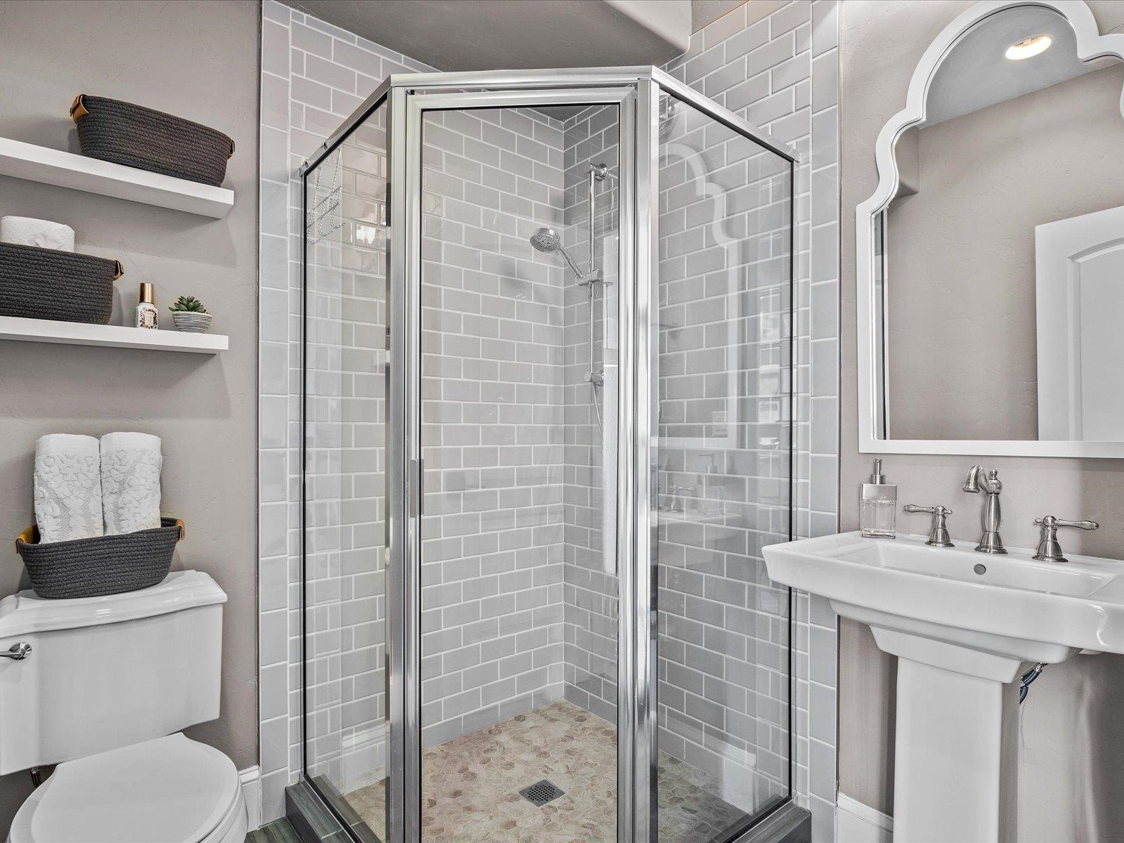 482 Riggs Way Grand Junction, CO 81507 - Photo 13 of 42 a bathroom with a shower sink vanity and toilet