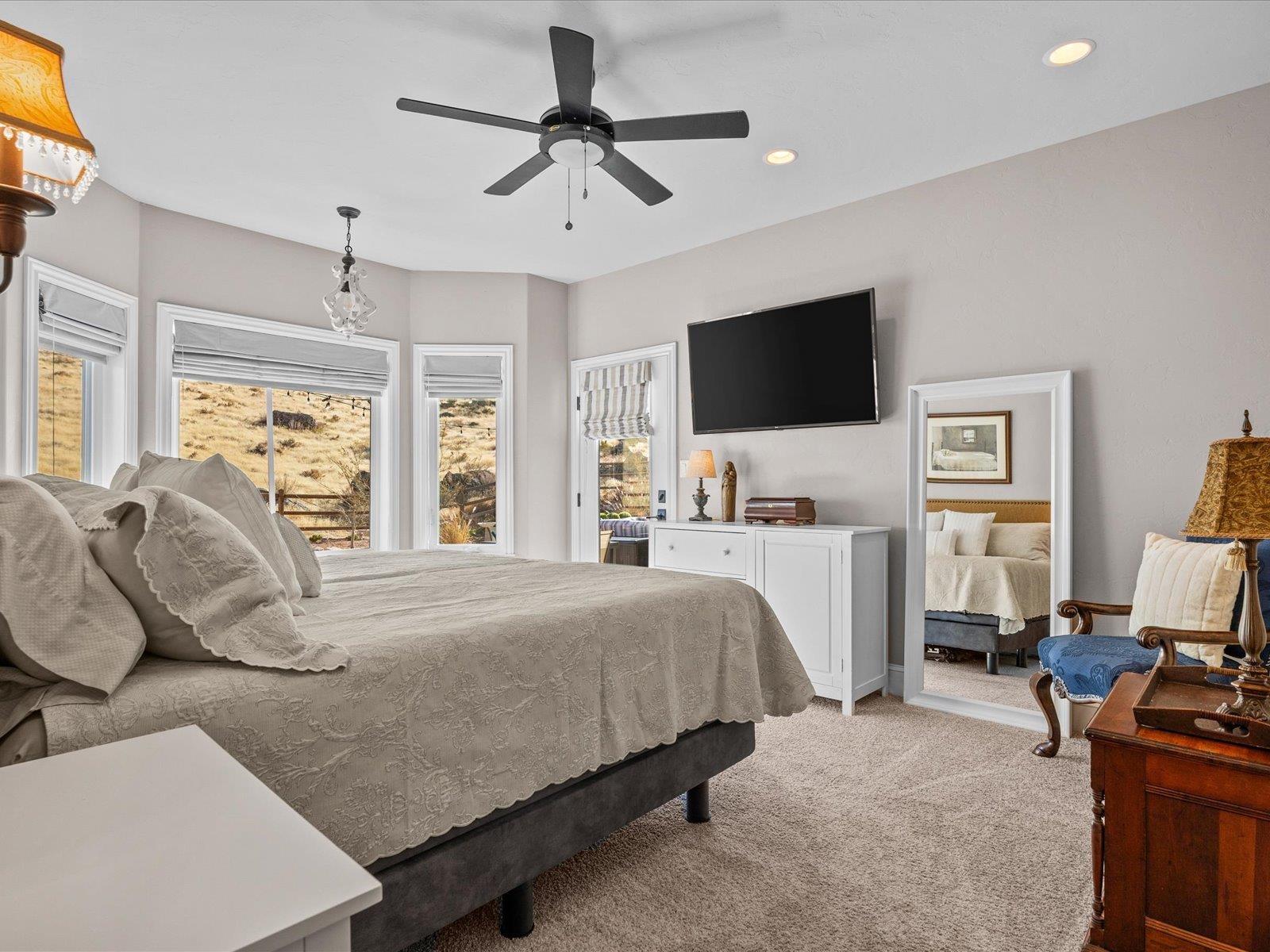 482 Riggs Way Grand Junction, CO 81507 - Photo 14 of 42 a bedroom with a bed a flat screen tv and a window