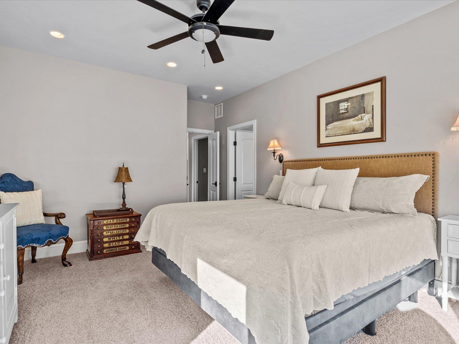 482 Riggs Way Grand Junction, CO 81507 - Photo 15 of 42 a bedroom with a bed and a chandelier