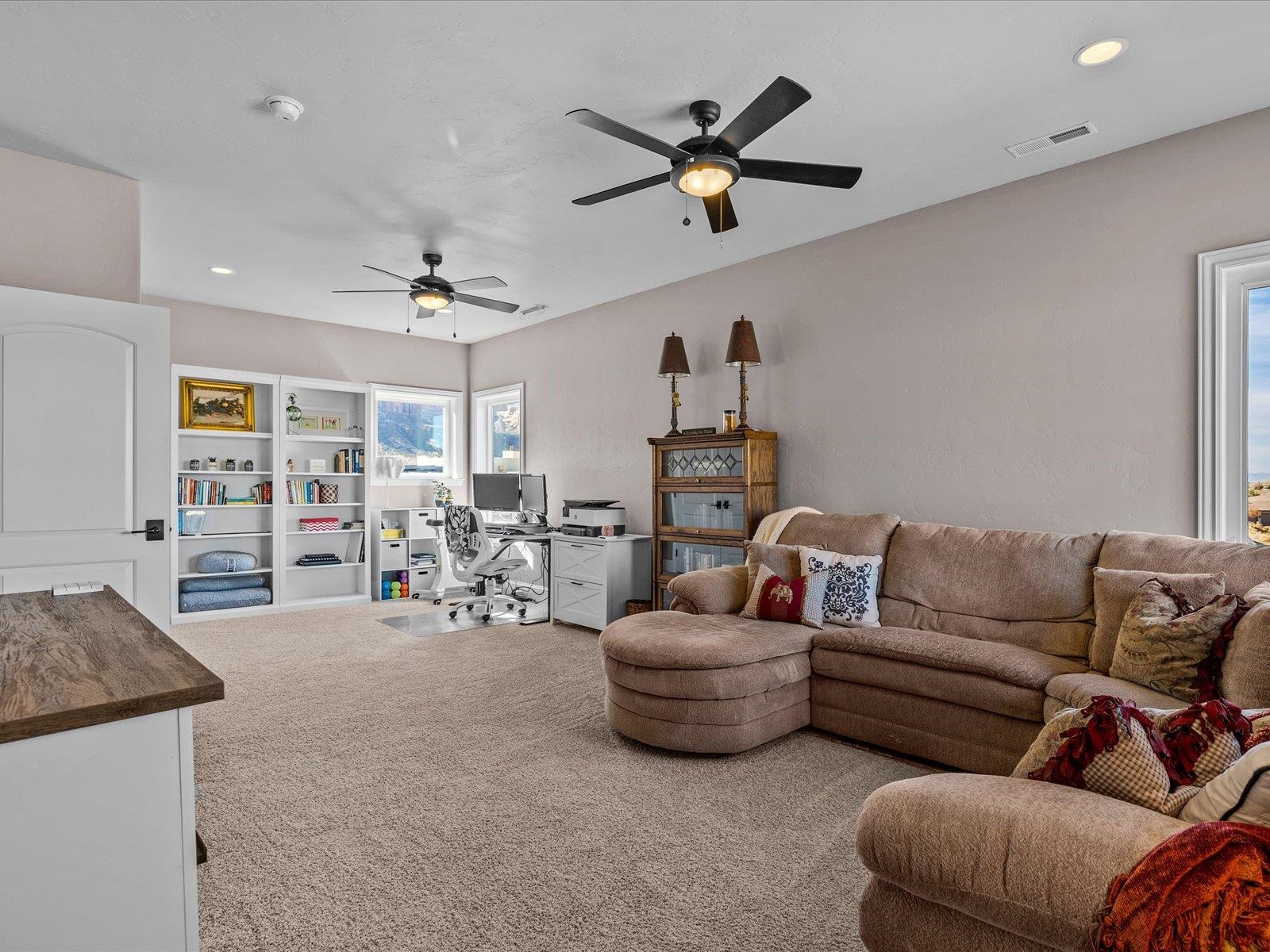 482 Riggs Way Grand Junction, CO 81507 - Photo 20 of 42 a living room with furniture and a ceiling fan