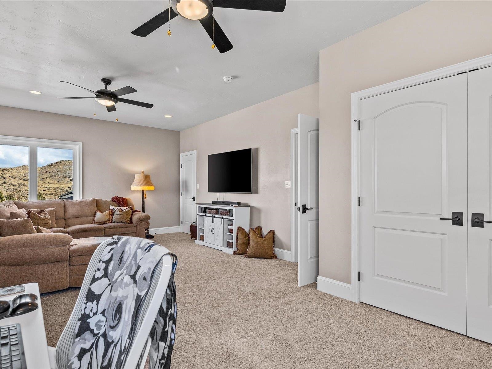 482 Riggs Way Grand Junction, CO 81507 - Photo 21 of 42 a living room with furniture and a flat screen tv