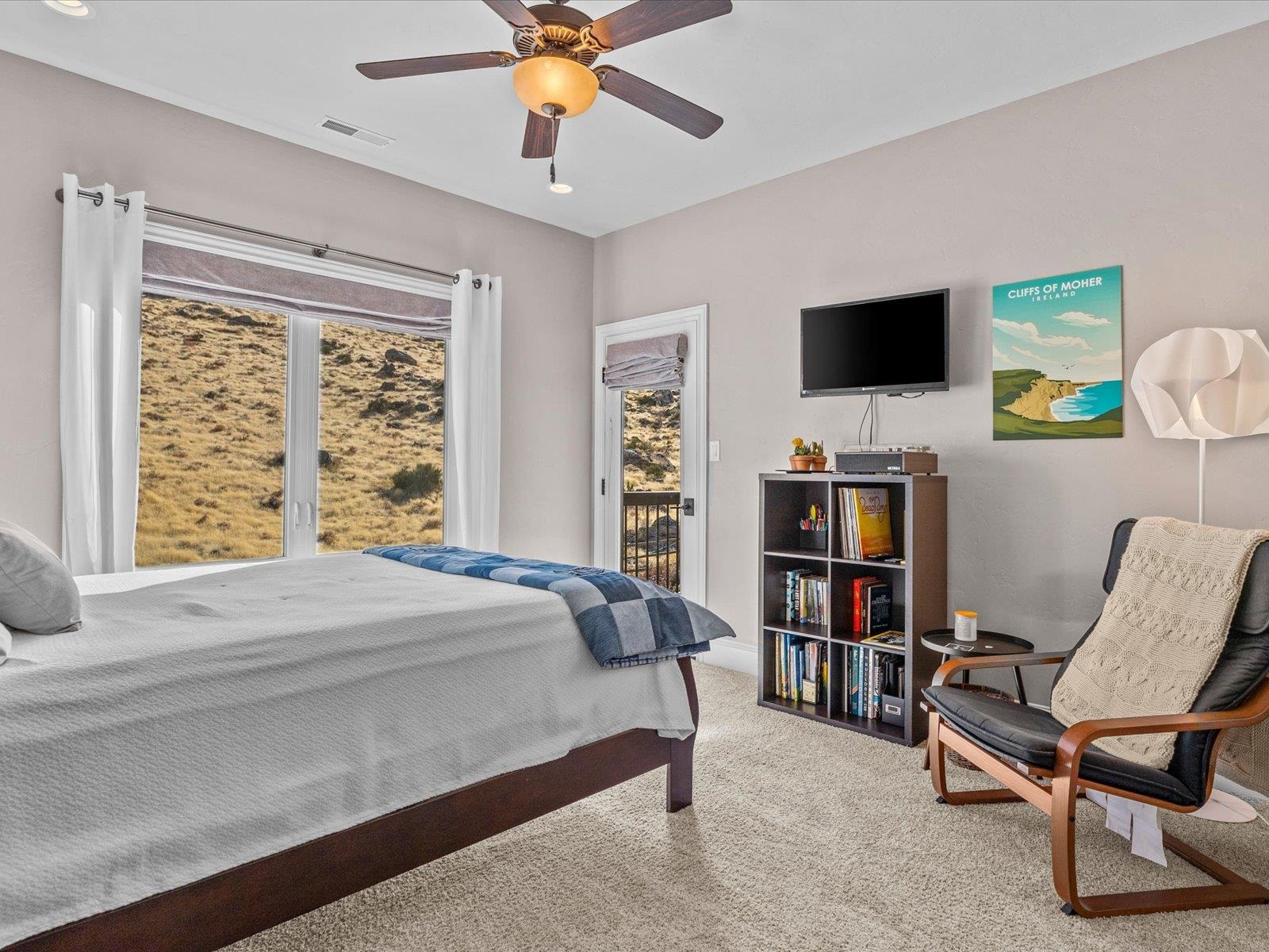 482 Riggs Way Grand Junction, CO 81507 - Photo 22 of 42 a bedroom with a bed and a flat screen tv