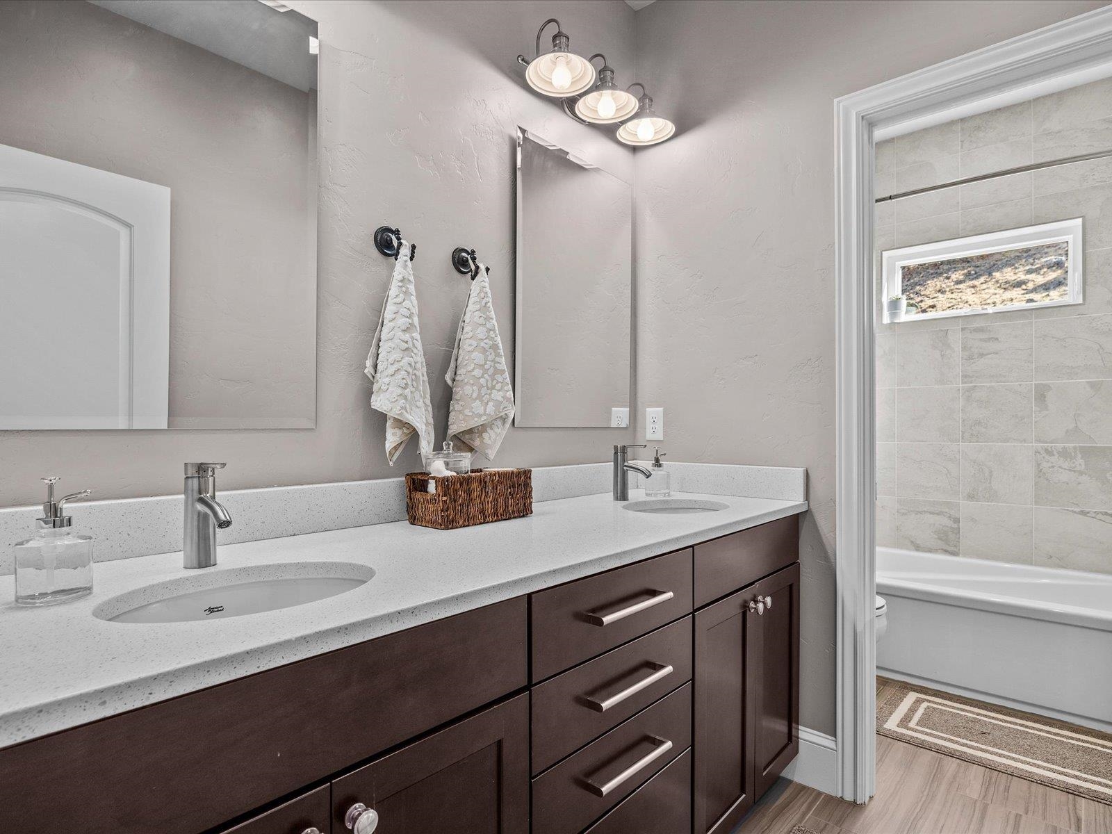 482 Riggs Way Grand Junction, CO 81507 - Photo 25 of 42 a bathroom with a double vanity sink and a mirror