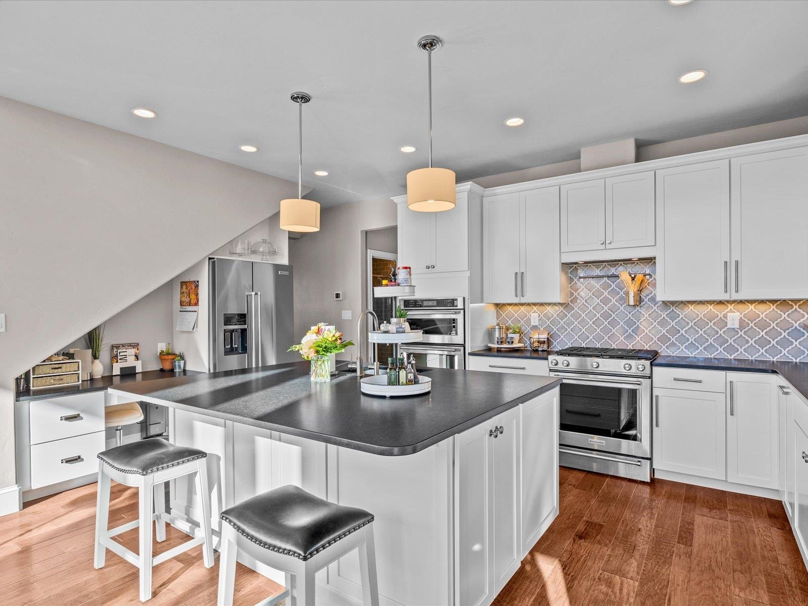 482 Riggs Way Grand Junction, CO 81507 - Photo 8 of 42 a kitchen with stainless steel appliances granite countertop a stove top oven a sink a counter space and cabinets