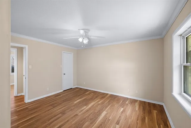 wooden floor in an empty room with a window