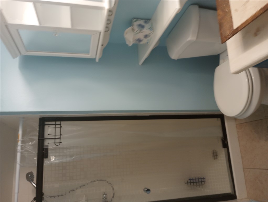 1190 Ramar Road, Unit 37 Bullhead City, AZ 86442 - Photo 11 of 14 a white toilet sitting next to a bathroom sink