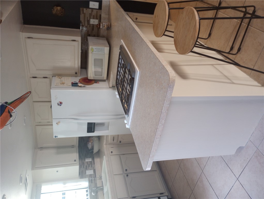1190 Ramar Road, Unit 37 Bullhead City, AZ 86442 - Photo 3 of 14 a kitchen with a stove a refrigerator and a sink