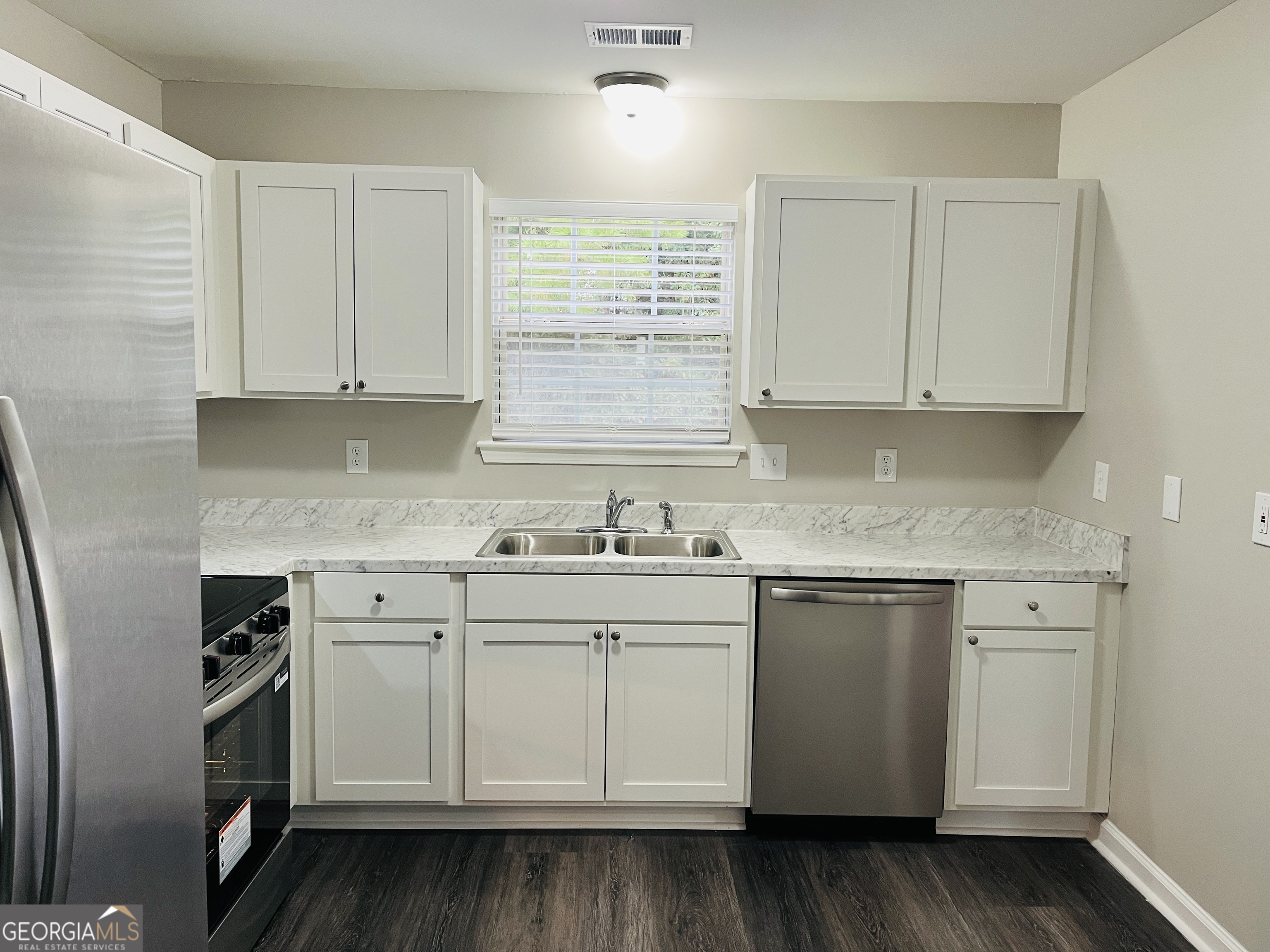 3510 Brookstone Way Union City, GA 30291 - Photo 11 of 32 a kitchen with granite countertop white cabinets and white appliances