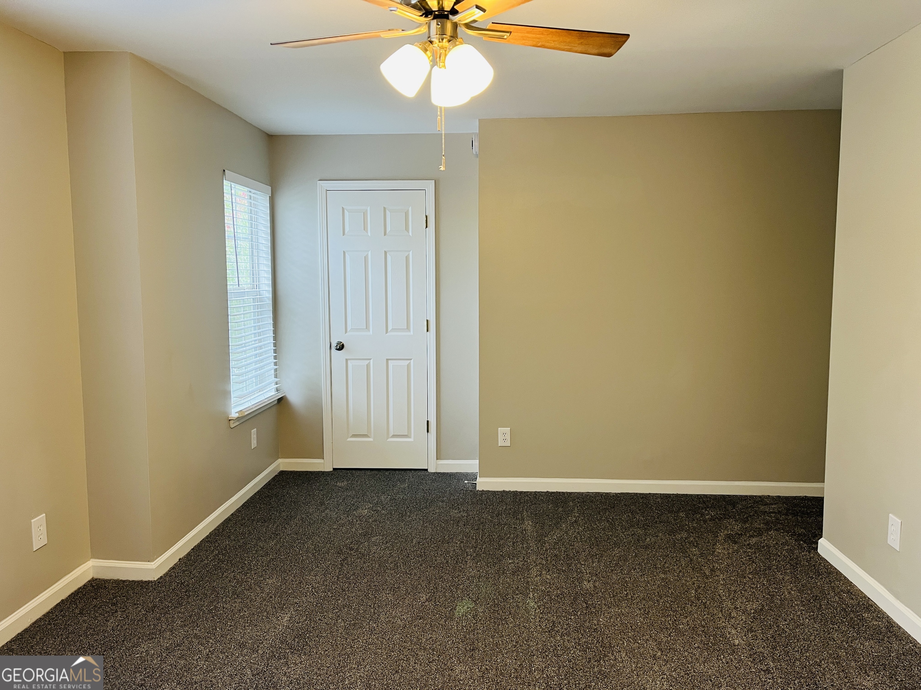 3510 Brookstone Way Union City, GA 30291 - Photo 15 of 32 an empty room with a window and a ceiling fan