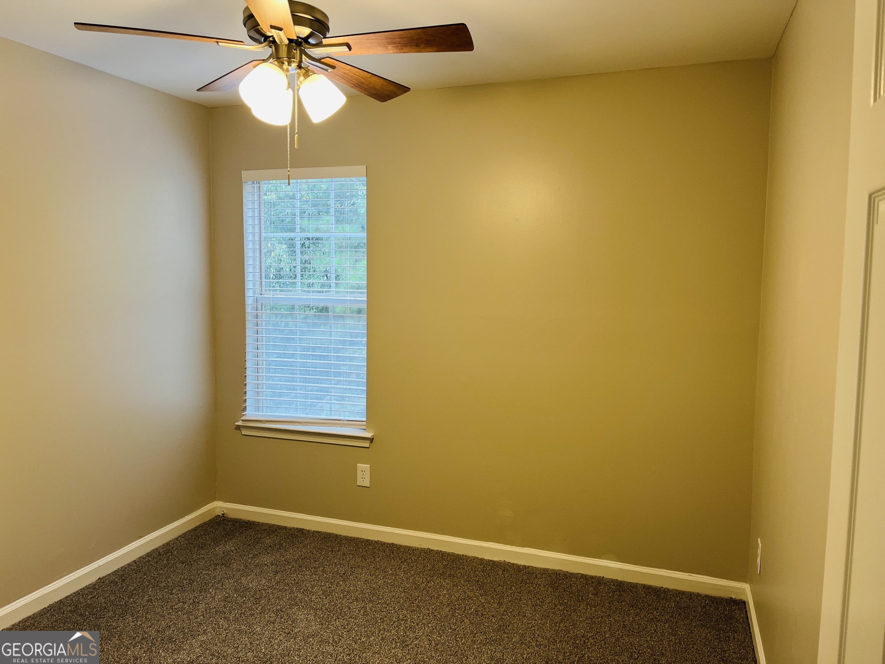 3510 Brookstone Way Union City, GA 30291 - Photo 19 of 32 an empty room with a window and a fan