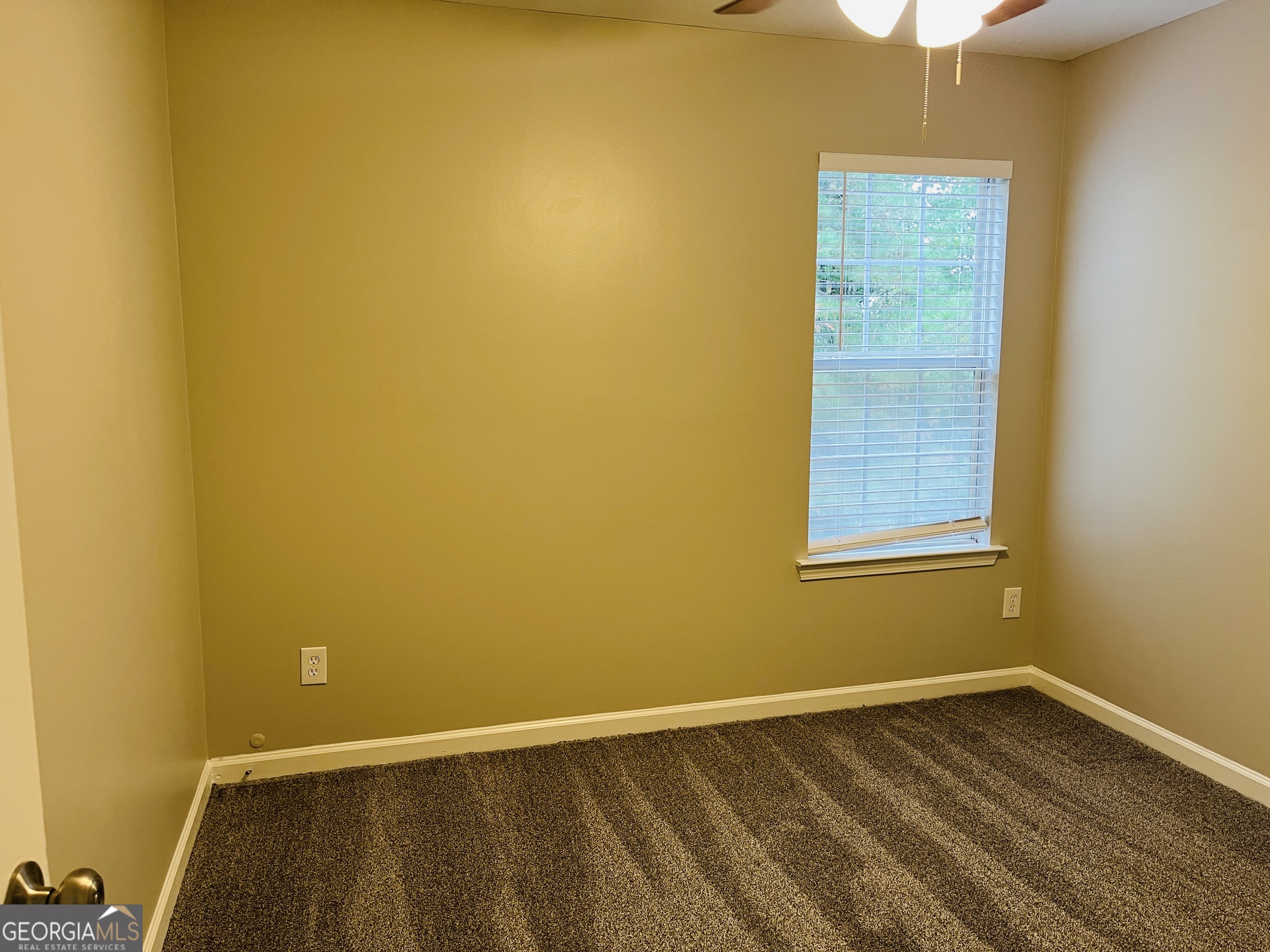 3510 Brookstone Way Union City, GA 30291 - Photo 23 of 32 a view of an empty room with wooden floor and a window
