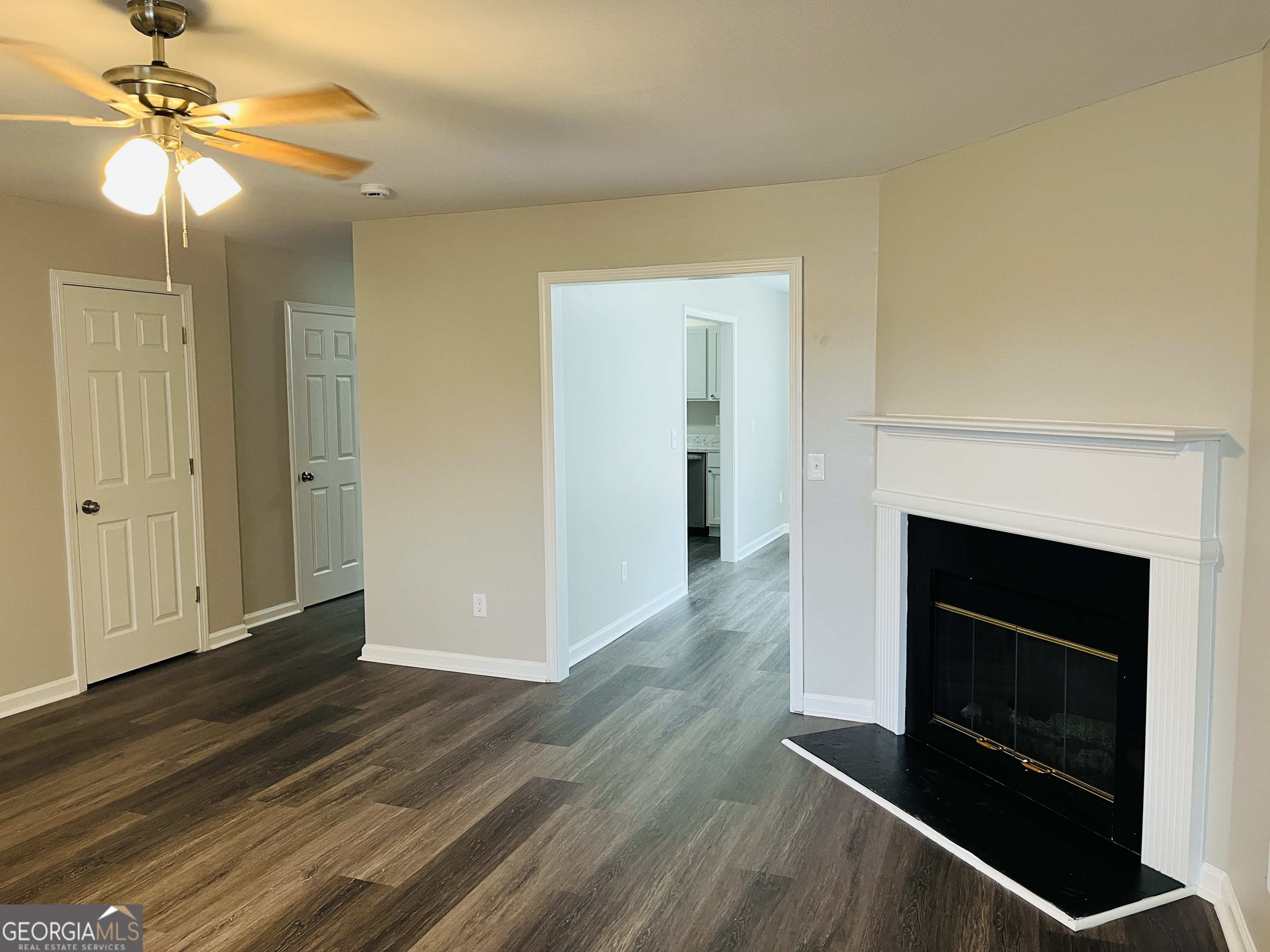 3510 Brookstone Way Union City, GA 30291 - Photo 5 of 32 a view of an empty room with wooden floor fireplace and a window