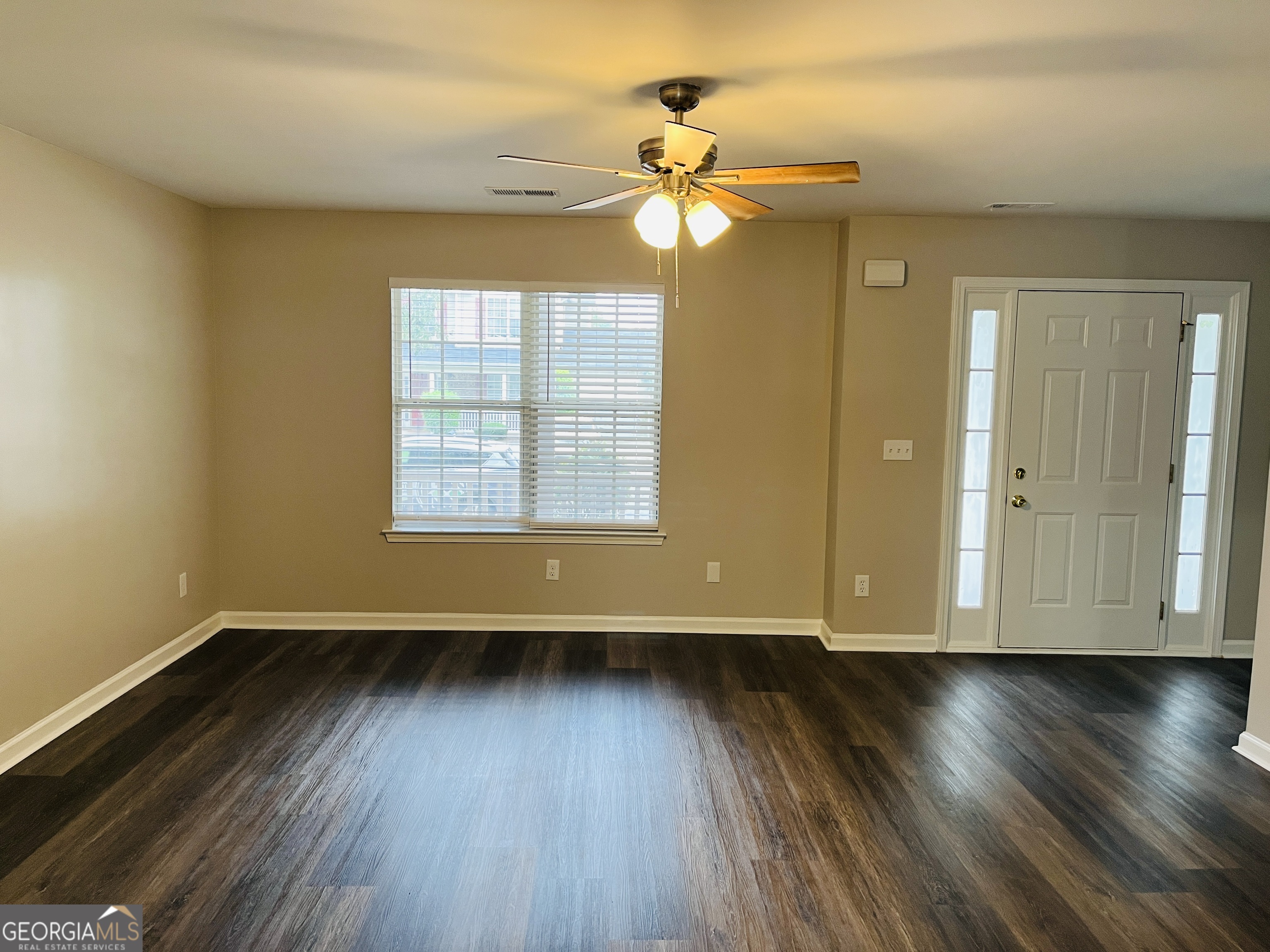 3510 Brookstone Way Union City, GA 30291 - Photo 6 of 32 a view of an empty room with wooden floor and a window