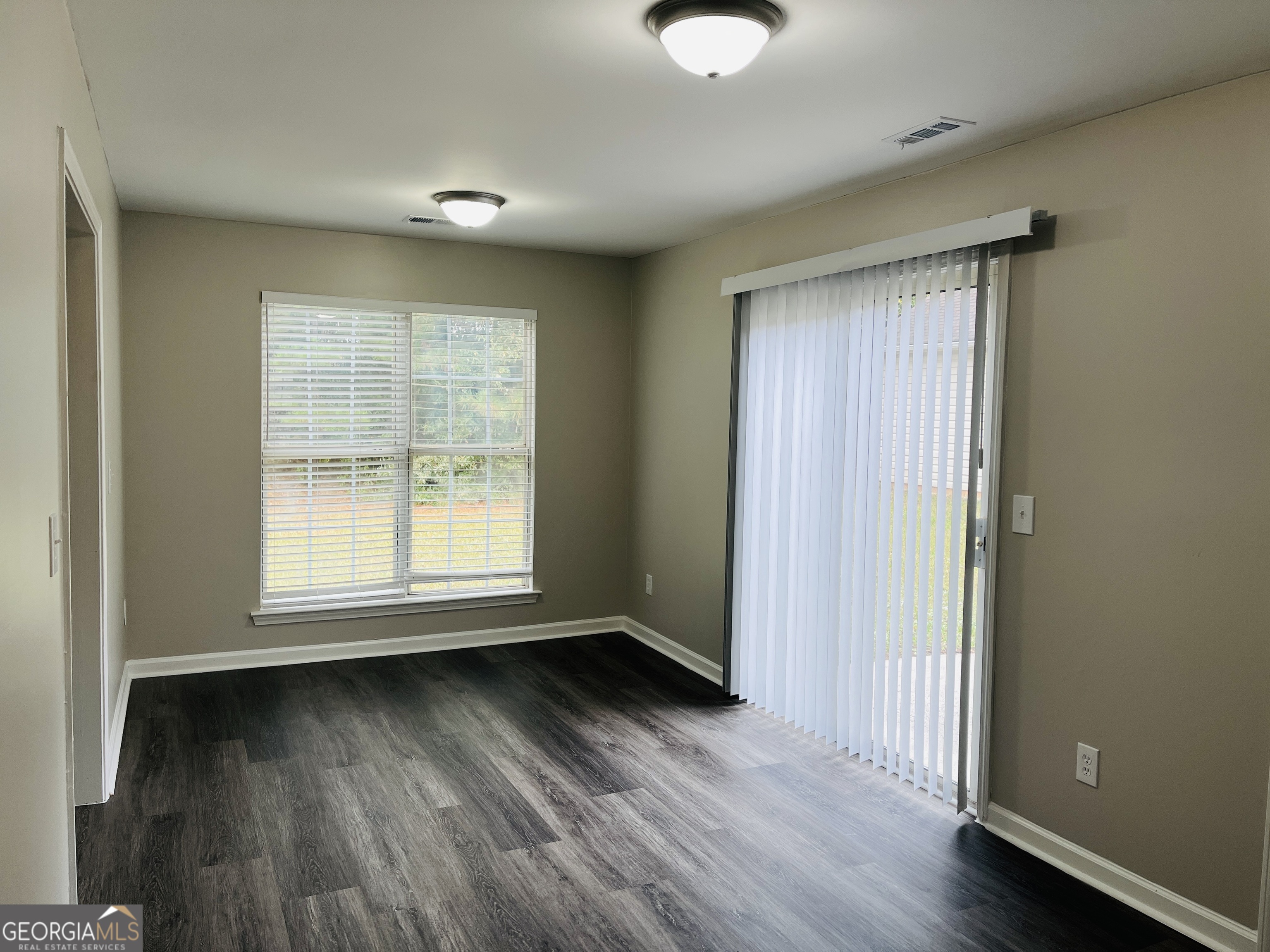 3510 Brookstone Way Union City, GA 30291 - Photo 7 of 32 an empty room with wooden floor and windows