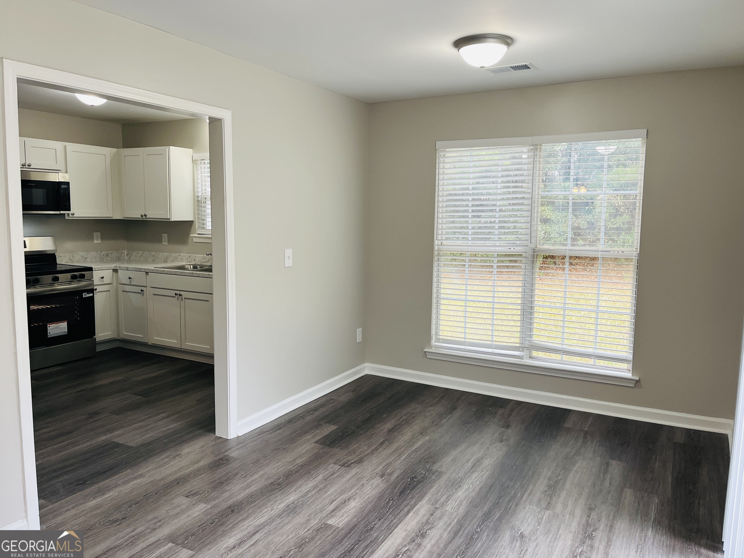 3510 Brookstone Way Union City, GA 30291 - Photo 8 of 32 an empty room with wooden floor and a window