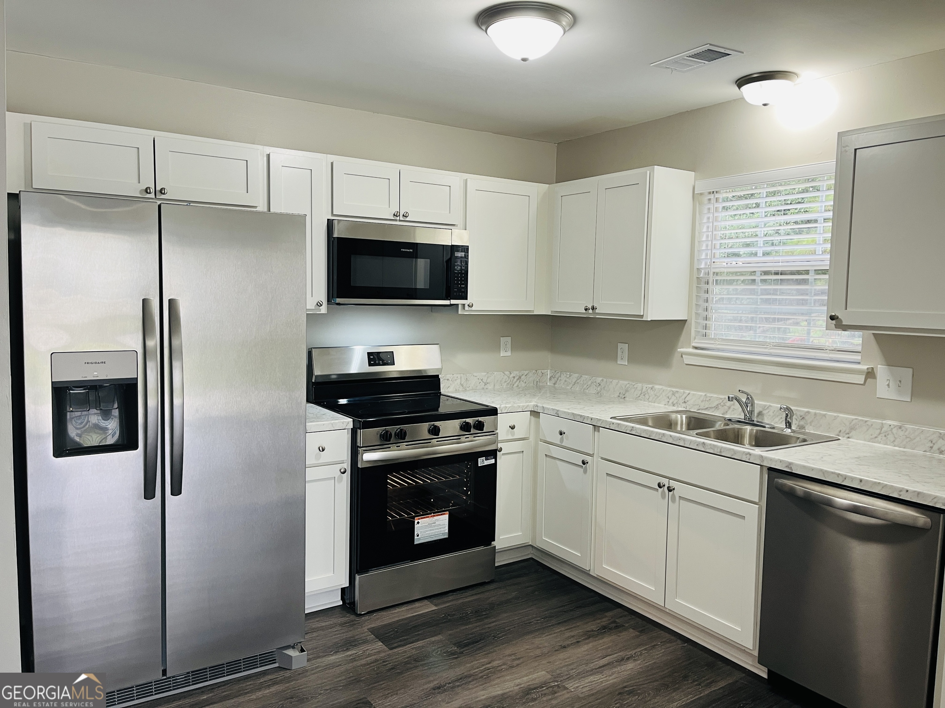 3510 Brookstone Way Union City, GA 30291 - Photo 10 of 32 a kitchen with a sink stainless steel appliances and white cabinets