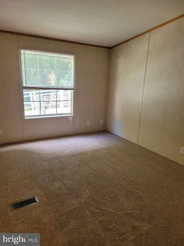an empty room with a empty space and windows