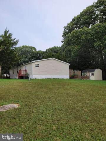 a aerial view of a house with pool garden and trees
