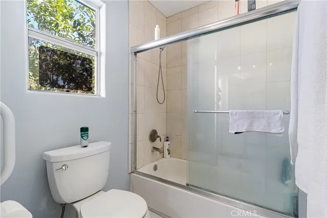 a bathroom with a toilet a sink and a shower