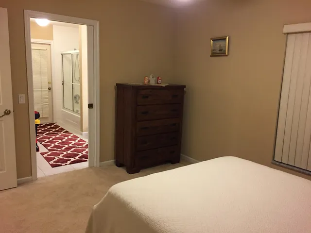 a bedroom with a bed and a dresser