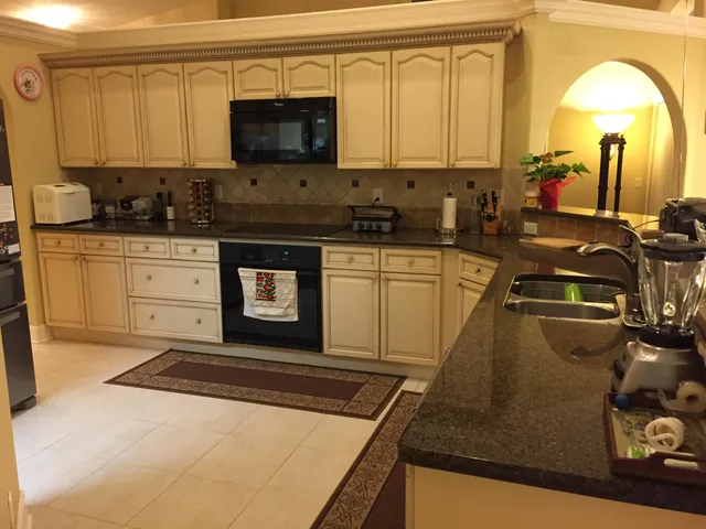 a kitchen with stainless steel appliances granite countertop a sink stove and cabinets