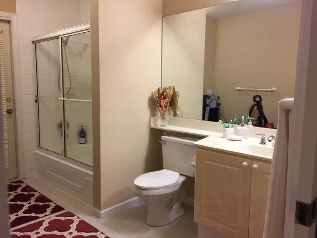 a bathroom with a sink a toilet and shower