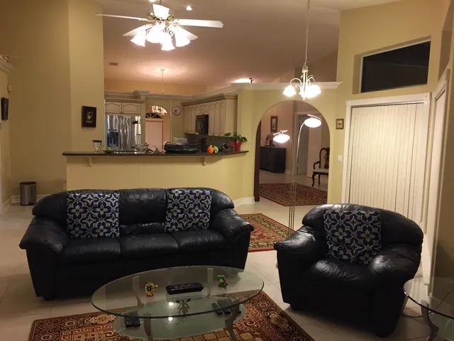 a living room with furniture and a chandelier