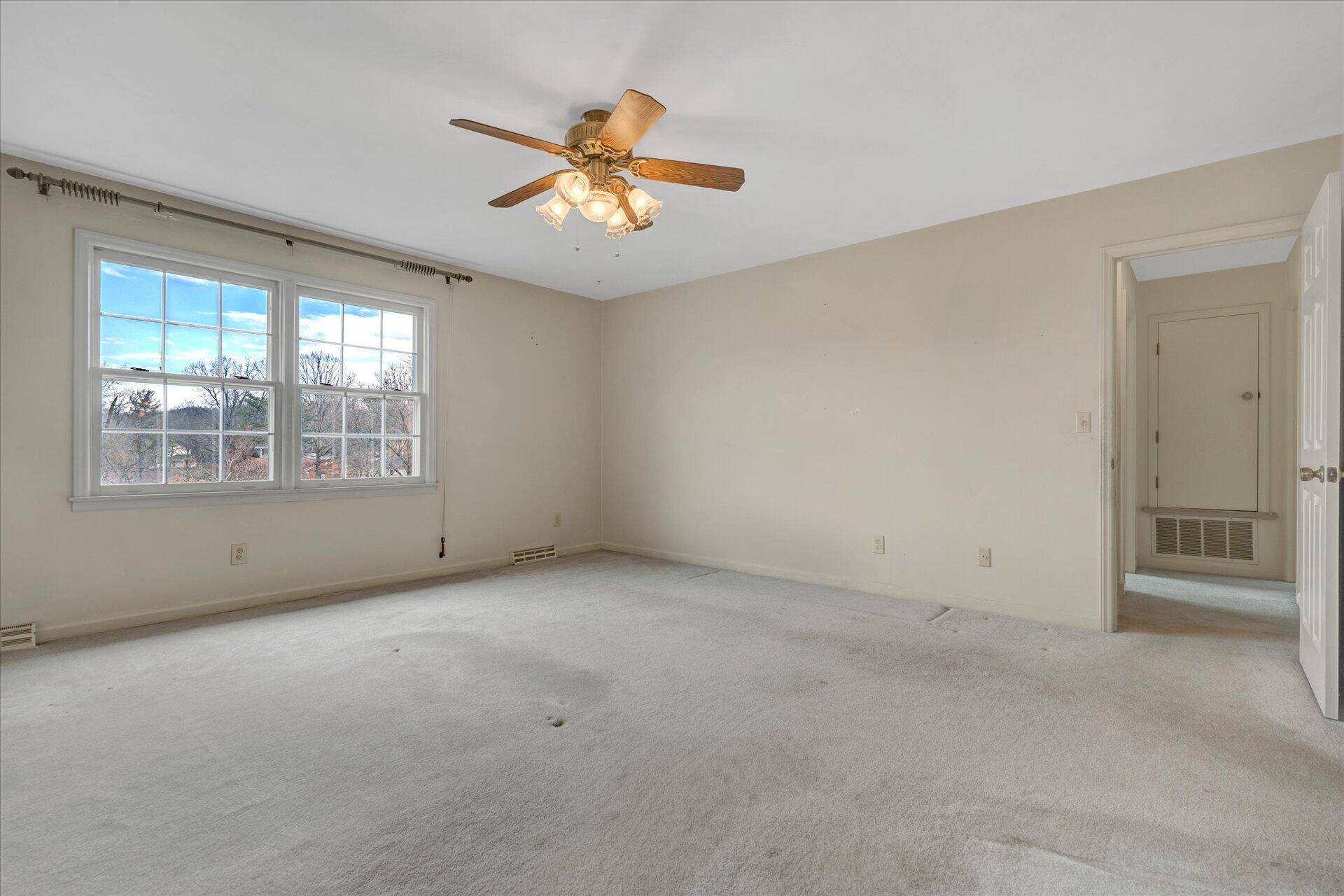 306 Ridgeview Road Blue Ridge, VA 24064 - Photo 21 of 30 an empty room with windows and fan