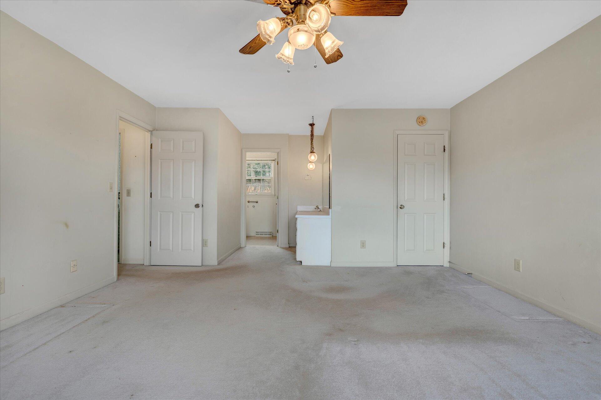 306 Ridgeview Road Blue Ridge, VA 24064 - Photo 23 of 30 an empty room with a chandelier fan and closet