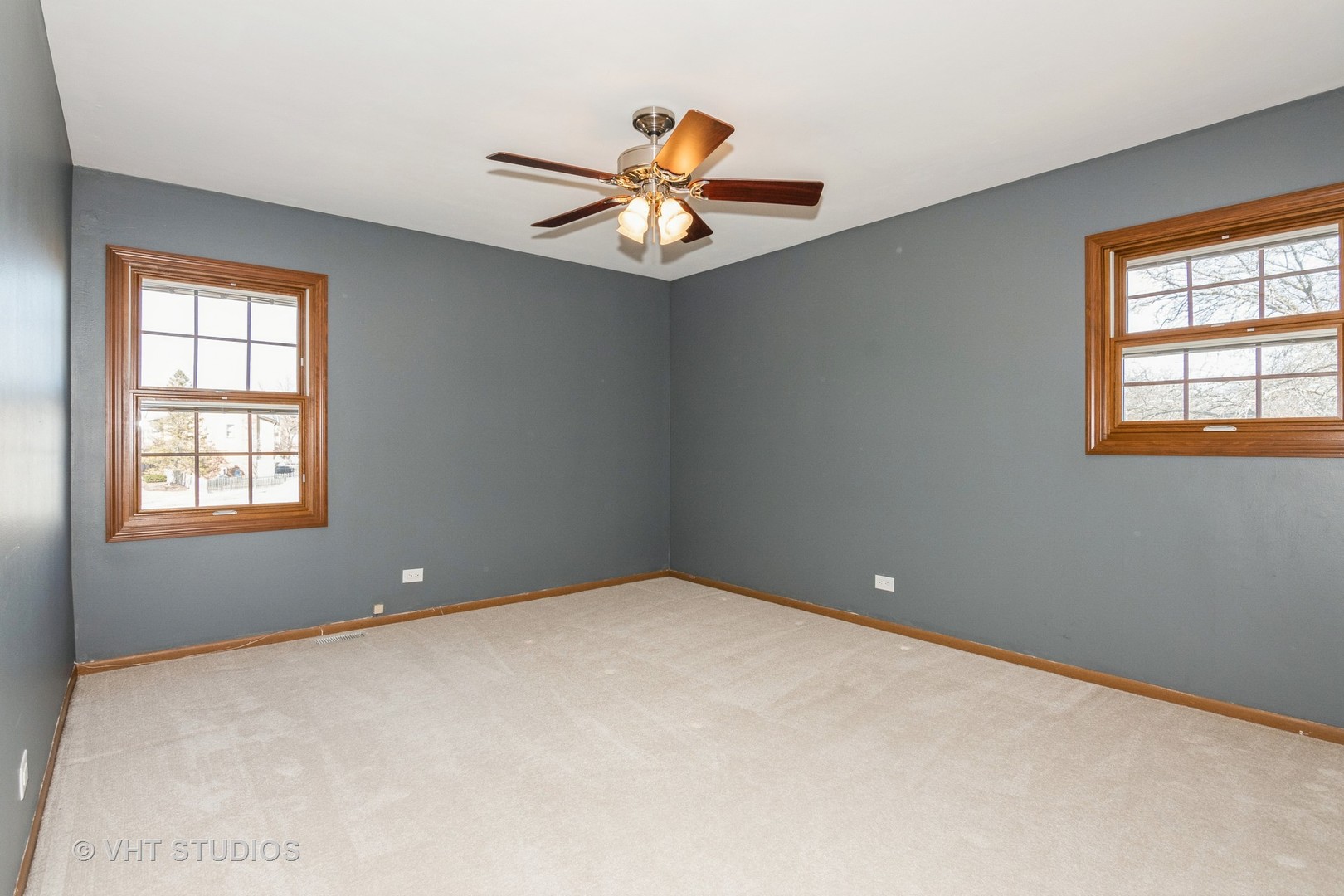 1295 Chatsworth Lane Hoffman Estates, IL 60169 - Photo 15 of 24 an empty room with a chandelier fan and windows
