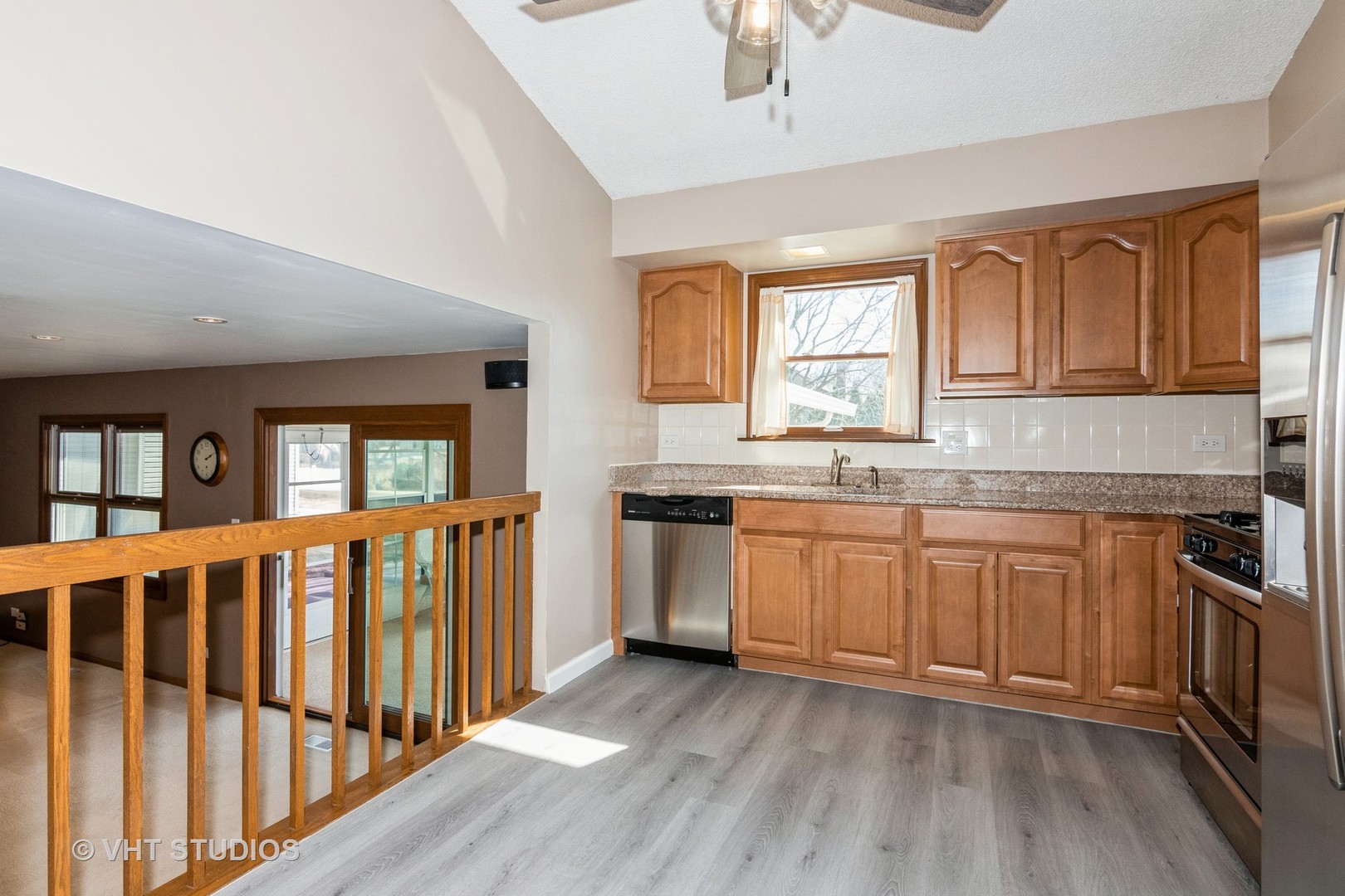 1295 Chatsworth Lane Hoffman Estates, IL 60169 - Photo 6 of 24 a kitchen with granite countertop a stove top oven a sink dishwasher a dining table and chairs with wooden floor
