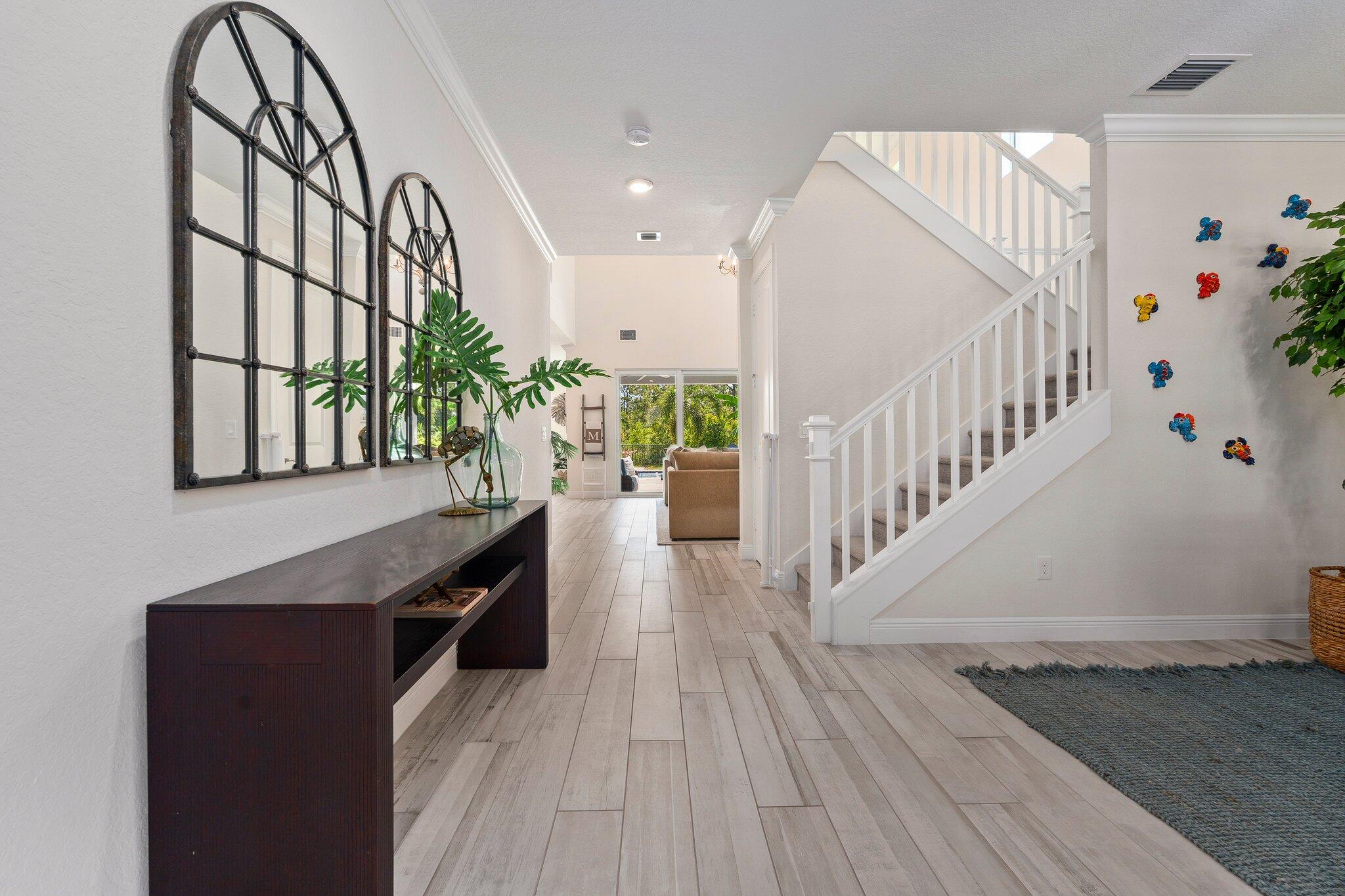 4701 Southwest Ardsley Drive Stuart, FL 34997 - Photo 11 of 83 a view of entryway and hall with wooden floor