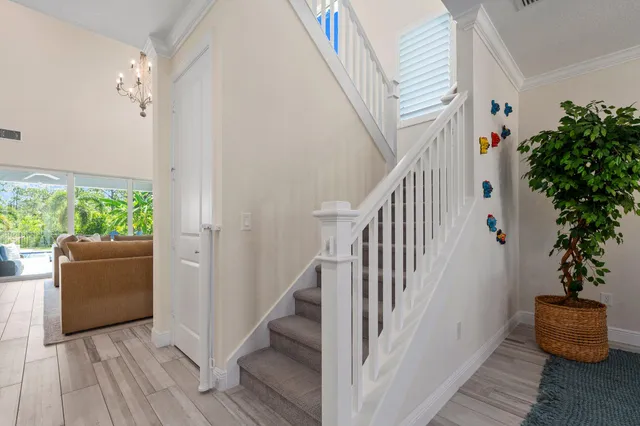 a dining room with furniture a chandelier and wooden floor
