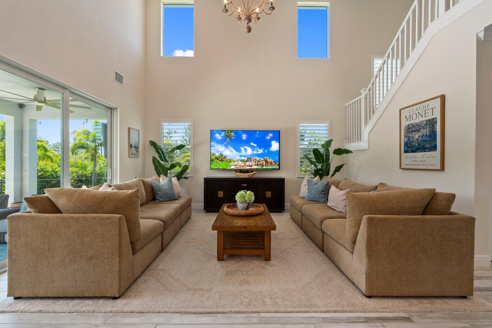 4701 Southwest Ardsley Drive Stuart, FL 34997 - Photo 13 of 83 a living room with furniture and a large window