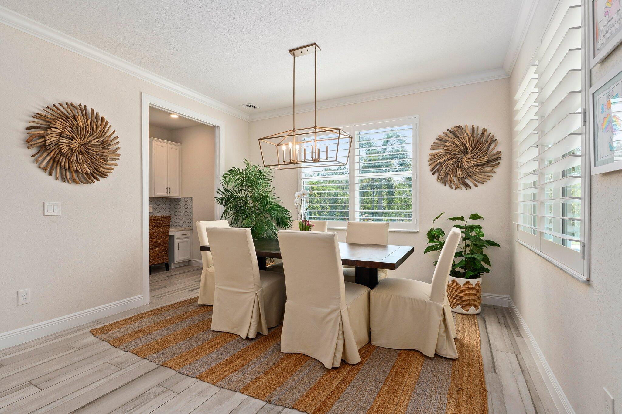4701 Southwest Ardsley Drive Stuart, FL 34997 - Photo 17 of 83 a view of a dining room with furniture window and wooden floor